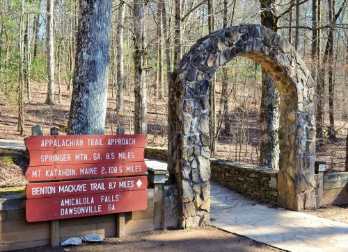 Stone archway marking the Appalachian Trail approach, with distance signs to Springer Mountain and Mount Katahdin.