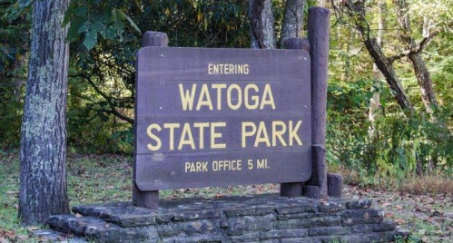 Sign marking the entrance to Watoga State Park, with directions to the park office 5 miles away.