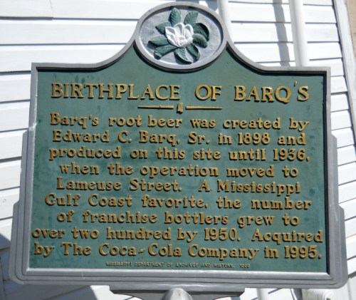Historical plaque detailing the birthplace of Barq's root beer, established in 1898 and acquired by Coca-Cola in 1995.