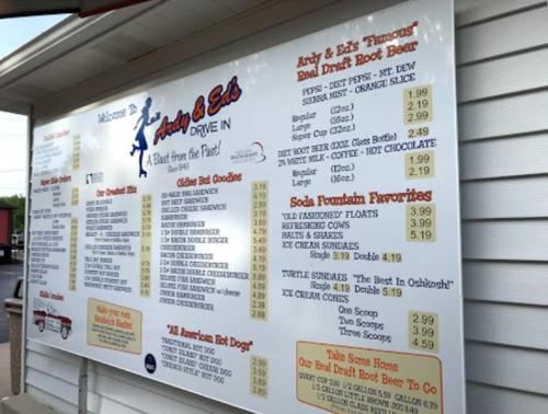Menu board at Andy & Ed's Drive-In featuring hot dogs, root beer, and various soda fountain favorites.