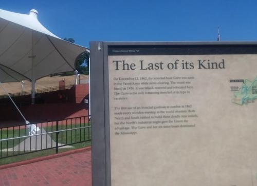 Sign about the last remaining ironclad boat, the Cairo, sunk in 1862, with a tent structure in the background.