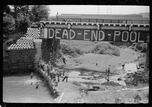 Black and white photo of a bridge labeled "DEAD-END POOL," with people swimming and relaxing by the water below.