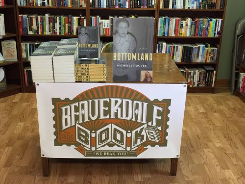 A display table at a bookstore featuring "Bottomland" by Michelle Hoover and a sign for Beaverdal Books.