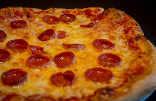 A close-up of a pepperoni pizza with melted cheese and a golden crust.