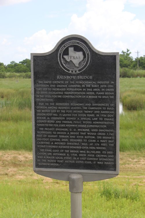 Historical marker for Rainbow Bridge, detailing its construction and significance in Texas' petrochemical industry.