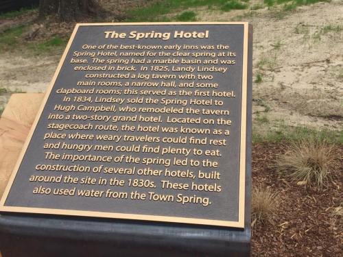 A historical plaque about the Spring Hotel, detailing its construction and significance in the 1830s.