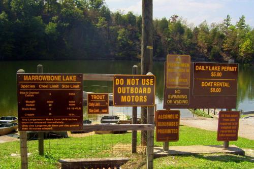 Signage at Marrowbone Lake detailing fishing regulations, permits, and restrictions on motorized boats and swimming.