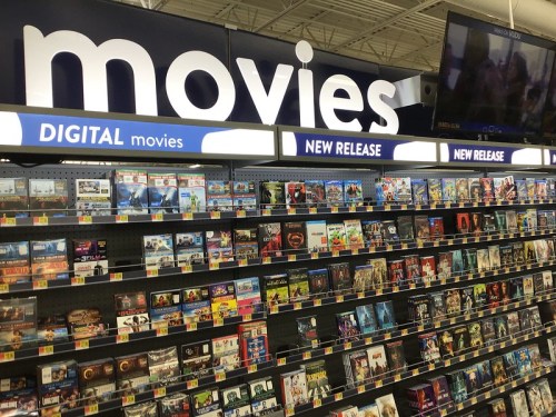 A display of movies in a store, featuring sections for digital and new release titles.