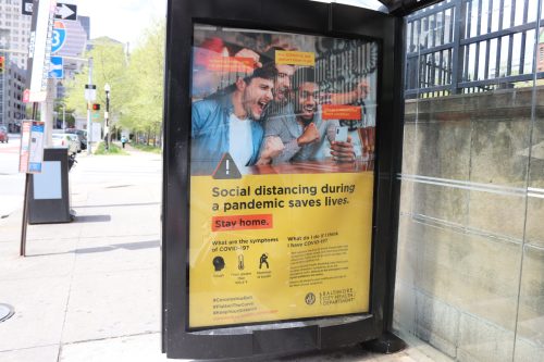 A public health poster promoting social distancing during the pandemic, encouraging people to stay home and stay safe.