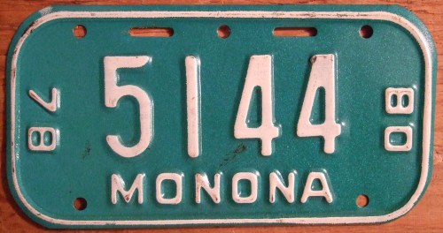 Vintage teal license plate with white numbers "5144" and the word "MONONA" at the bottom.