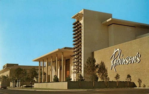 A mid-century modern building with a prominent sign reading "Robinson's," featuring columns and a unique spiral design.