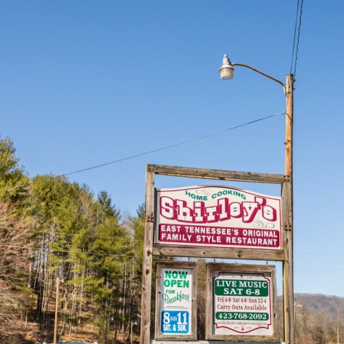 Sign for Shirley's, a family-style restaurant in East Tennessee, featuring live music and hours of operation.