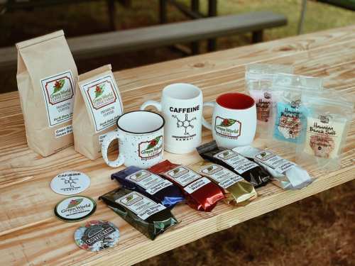 A wooden table displays various coffee products, mugs, and snacks, showcasing a cozy coffee-themed setup.