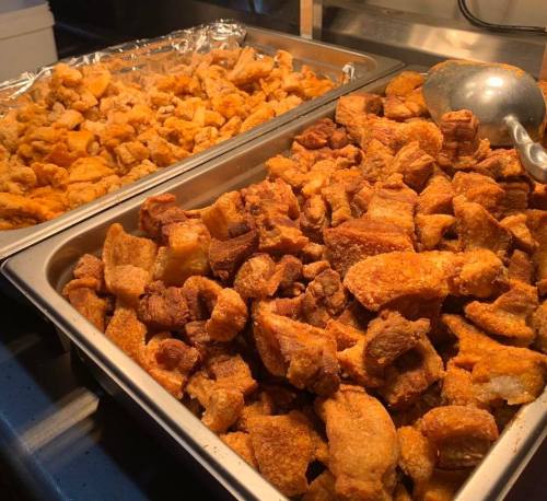 Two trays of crispy golden-brown fried pork cracklings, one tray slightly larger than the other.