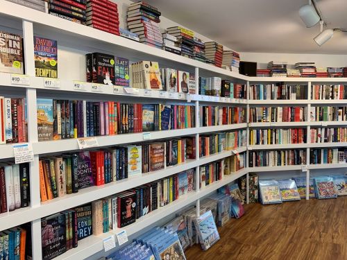 A cozy bookstore interior with shelves filled with a variety of books and colorful covers, creating a welcoming atmosphere.