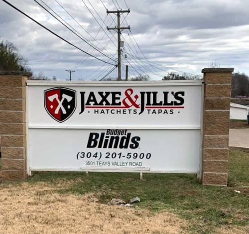 Sign for Jaxe & Jill's Hatchets and Tapas, featuring Budget Blinds, located at 3501 Teays Valley Road.
