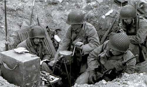 Soldiers in helmets working in a trench, surrounded by equipment and weapons during wartime.