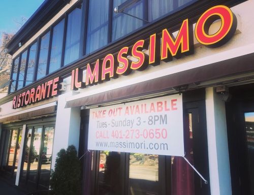 Sign for "Ristorante Il Massimo" with a banner advertising takeout services and contact information.