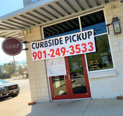 Sign for curbside pickup at Char Restaurant, featuring phone number and hours of operation.