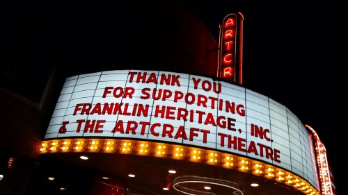 Marquee of the Artcraft Theatre at night, thanking supporters of Franklin Heritage, Inc. with bright lights.