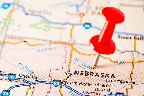 Close-up of a map showing Nebraska with a red pushpin marking the location.