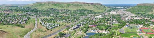 Aerial view of a green landscape with hills, residential areas, and a mix of industrial and recreational spaces.