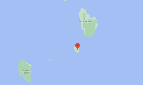 Map showing a small island marked with a red pin, surrounded by water and labeled Summer Island and St. Martin Island.