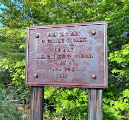 A weathered sign reads "John W. Storrs, Consulting Engineer, Built by American Bridge Company of New York, 1911."