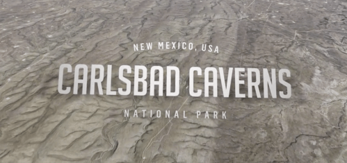 Aerial view of Carlsbad Caverns National Park in New Mexico, USA, with the park's name prominently displayed.