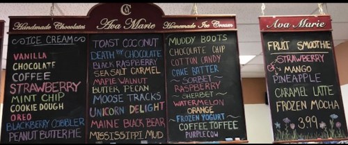 Chalkboard menu featuring ice cream, smoothies, and handmade chocolates with various flavors and prices listed.