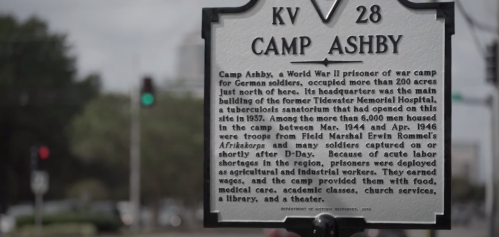 Historical marker for Camp Ashby, a WWII prisoner of war camp for German soldiers, detailing its history and significance.