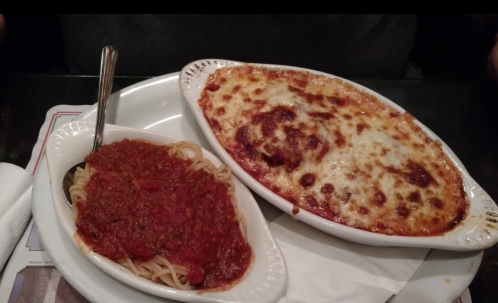 A plate of baked pasta with cheese and a side of spaghetti topped with marinara sauce.