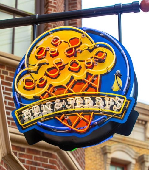 Neon sign of Ben & Jerry's featuring an ice cream cone against a blue background.