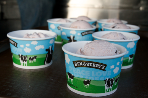 Several cups of Ben & Jerry's ice cream with a "Peace, Love, and Ice Cream" design, filled with scoops of ice cream.