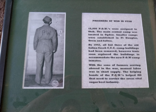Black and white photo of a soldier in a "P.W." uniform, with text about POW camps in Utah during WWII.