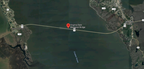 Aerial view of the Virginia Dare Memorial Bridge connecting Manns Harbor and Roanoke Island over water.