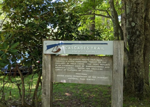 Sign for Cascades Trail at Blue Ridge Parkway, describing a 30-minute round trip walk through a forest to waterfalls.