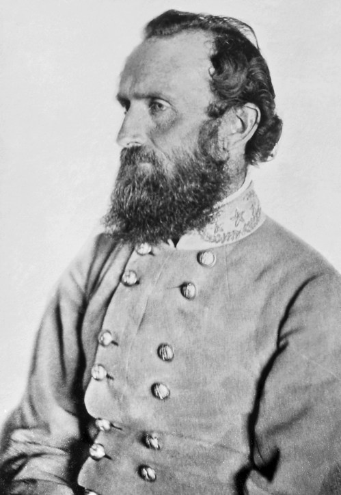 A historical black-and-white portrait of a bearded man in a military uniform, seated in profile.