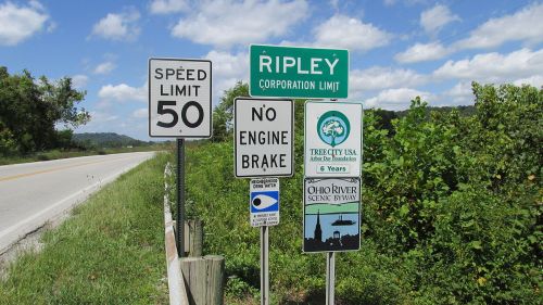 Roadside signs indicating the speed limit, no engine brake, and the Ripley corporation limit, with scenic byway information.
