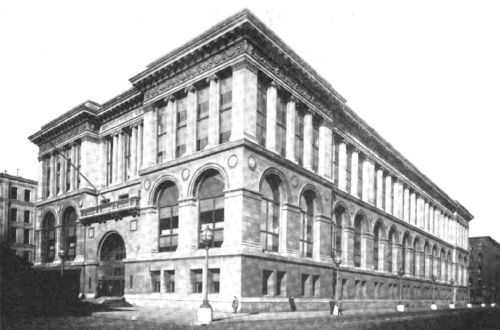 Historic building with a grand façade, featuring large arches and decorative elements, set in an urban environment.
