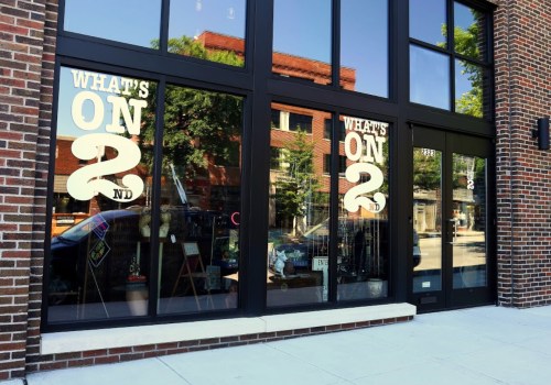 Storefront with large windows displaying the text "What's On 2nd" and reflections of the street outside.