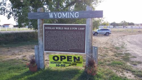 Sign for the Douglas World War II POW Camp in Wyoming, with an "Open" banner for visiting hours.
