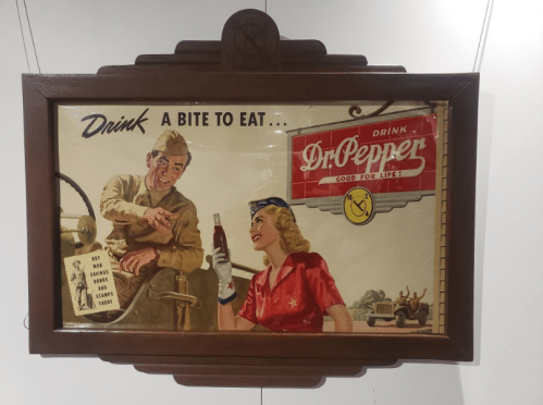 Vintage advertisement featuring a soldier and a woman enjoying Dr. Pepper, with the slogan "Drink a bite to eat."