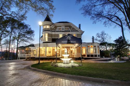 Historic hotel exterior at dusk, featuring a grand entrance, fountain, and elegant architectural details.