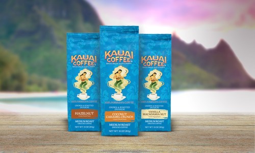 Three bags of Kauai Coffee featuring flavors: Hazelnut, Coconut Caramel Crunch, and Vanilla Macadamia Nut against a scenic backdrop.