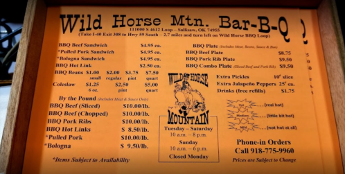 Menu for Wild Horse Mountain Bar-B-Q featuring various BBQ dishes and prices, including sandwiches and plates.