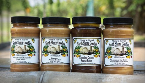 Four jars of North Shore Goodies peanut butter in various flavors: Chocolate Raspberry, Coconut, Chocolate Coconut, and Macadamia Nut.