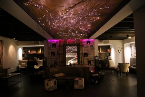 A modern lounge with soft lighting, cozy seating, and decorative elements, creating a warm and inviting atmosphere.