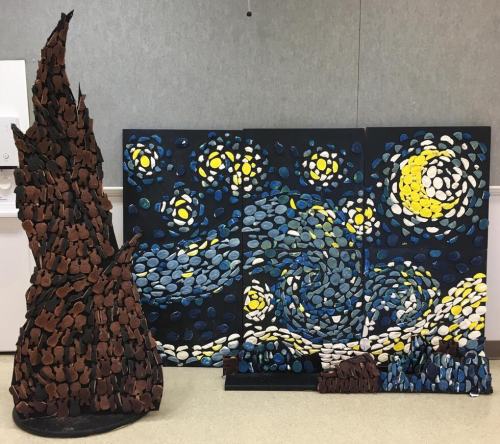 Art installation featuring a textured sculpture and a triptych inspired by "The Starry Night" with vibrant colors.