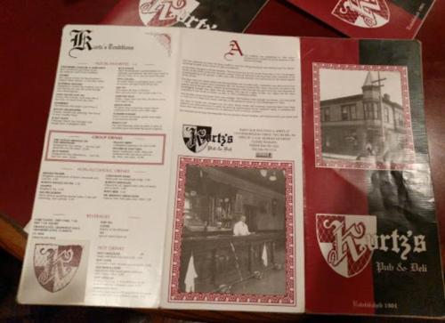 A menu from Kurtz's Pub & Deli featuring food options, beverages, and historical photos. Established 1901.